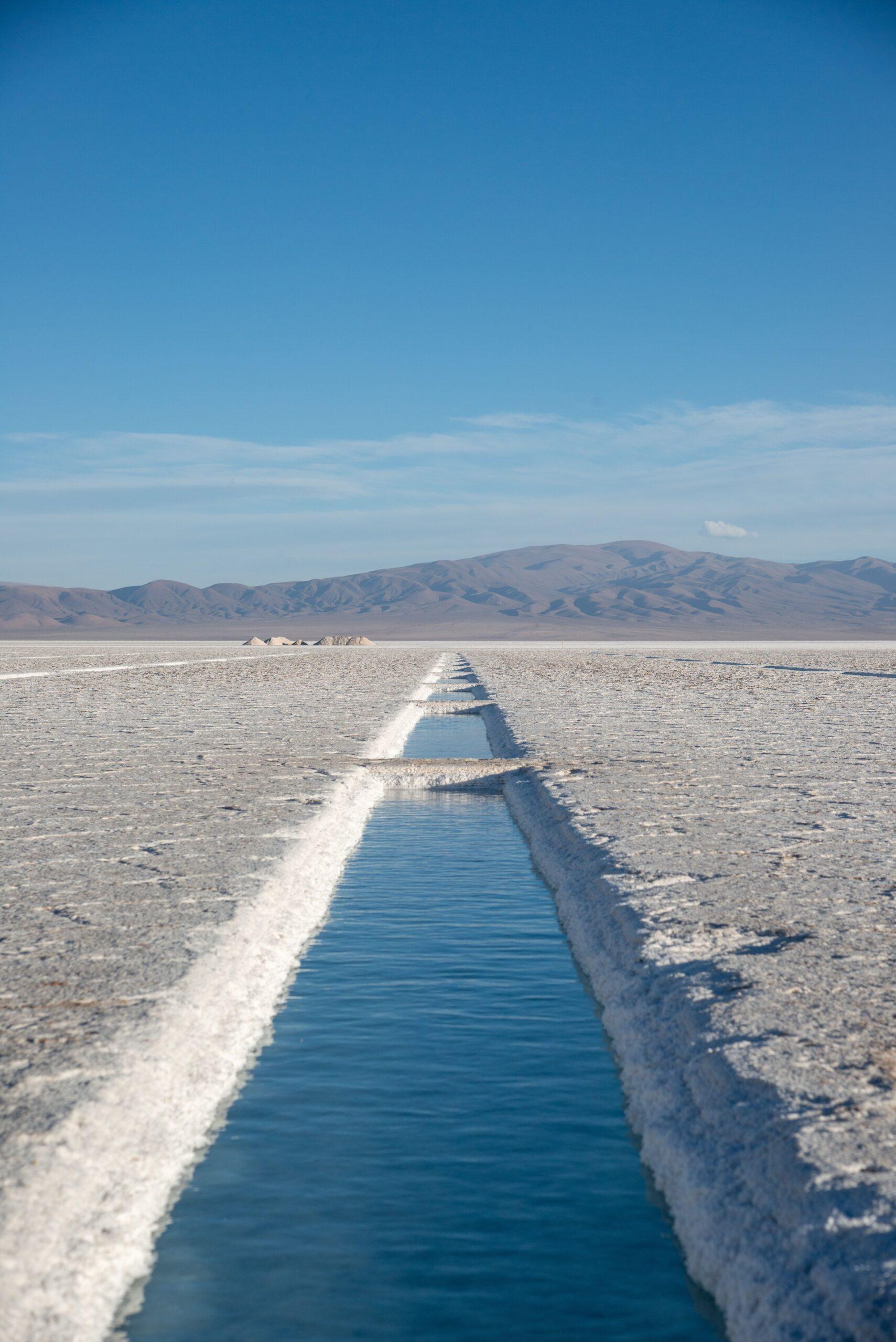 Vast expanse of Salinas Grandes salt flats in Salta, Argentina under clear skies.